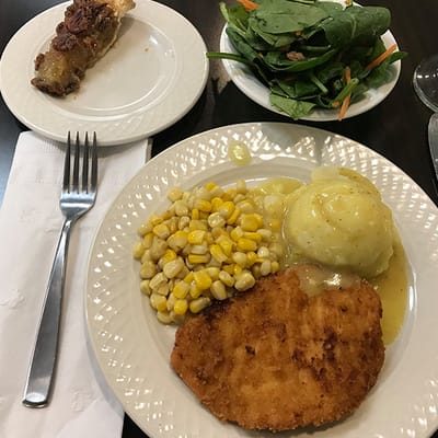 Dinner plate with chicken, corn, mashed potatoes, and salad
