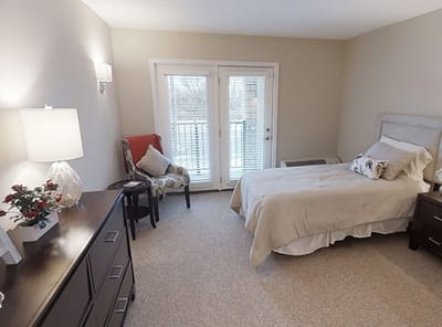 Private resident room with a bed and a chair