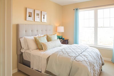 Cozy bedroom with soft lighting and decorative pillows