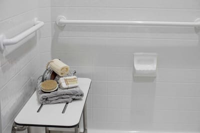 Accessible bathroom amenities with towels and a brush