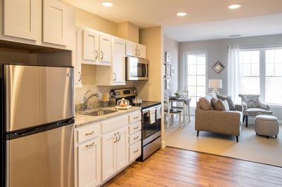 Well-designed kitchen and living area in a senior living unit