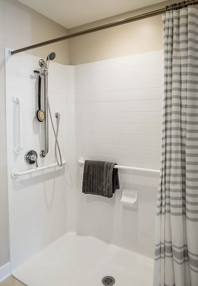 Accessible shower space with grab bars and towels