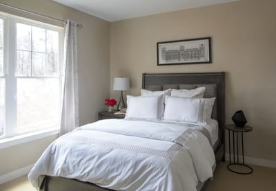 A cozy bedroom with natural light and simple decor