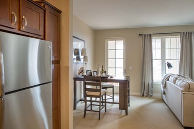 Cozy interior of a senior living unit with desk and sofa