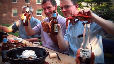 Residents enjoying a crab feast outdoors with drinks