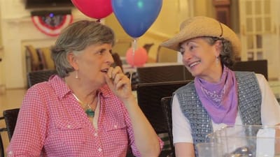 Two women enjoying a conversation at a celebration