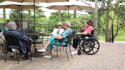Residents enjoying the outdoors at a patio area
