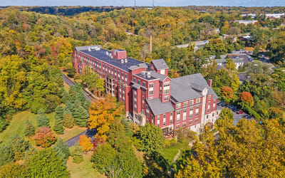 Aerial view of the facility surrounded by autumn foliage