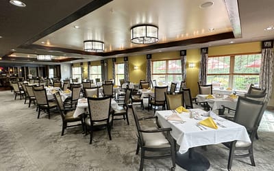 Dining room set for a meal with floral centerpieces