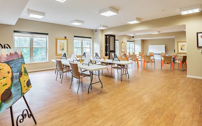 Bright activity room with easels and artwork