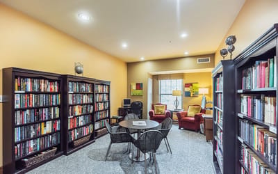 A cozy library area with bookshelves and seating