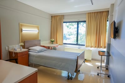 A private resident room with a bed and window