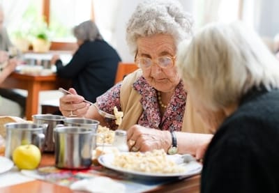 Residents enjoying a meal in a dining room