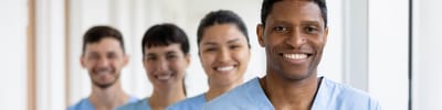 Healthcare staff smiling in a corridor