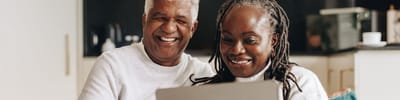 Senior couple enjoying time together with a laptop