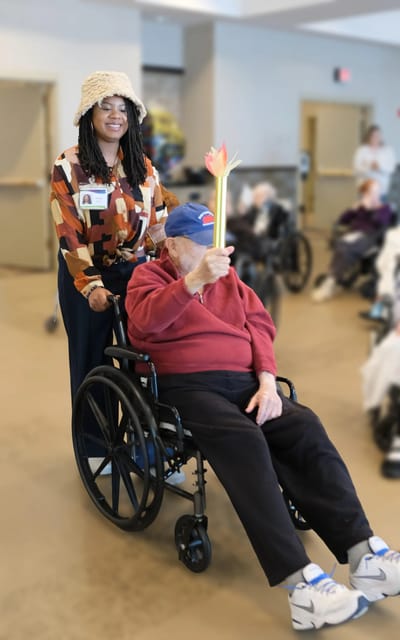 Staff member assisting a resident in a common area