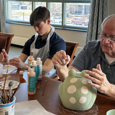 Residents engaging in a pottery painting activity