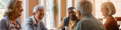 Residents enjoying conversation in a bright common area