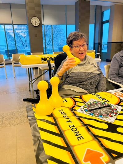 Resident enjoying a game in a common area