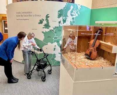 Residents engaging with an exhibit in a common area