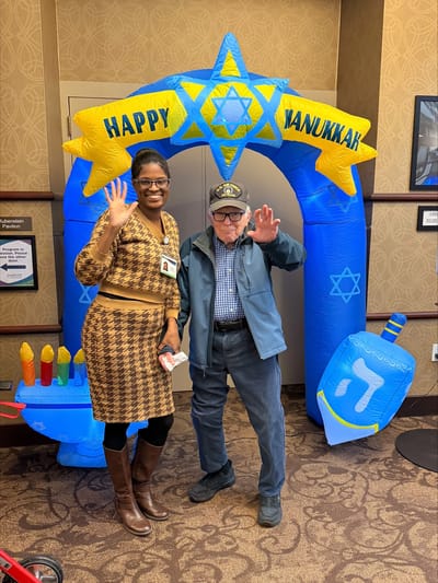Staff member and resident celebrating Hanukkah