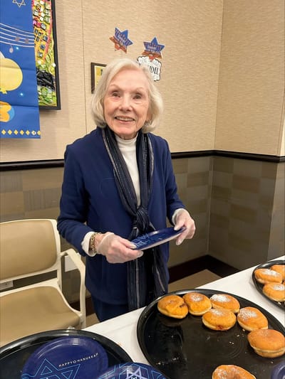 Resident celebrating Hanukkah with donuts