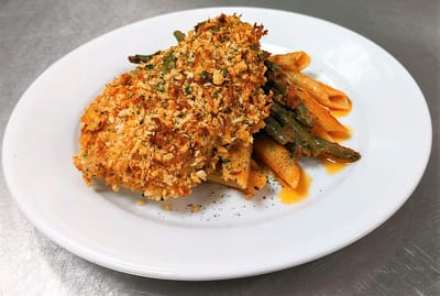 A plated meal with chicken, pasta, and green beans