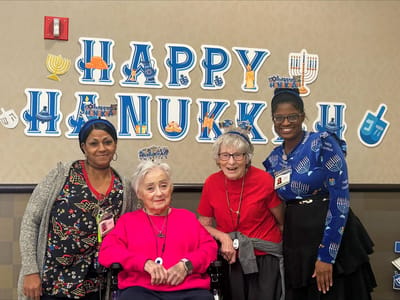 Residents celebrating Hanukkah with staff members