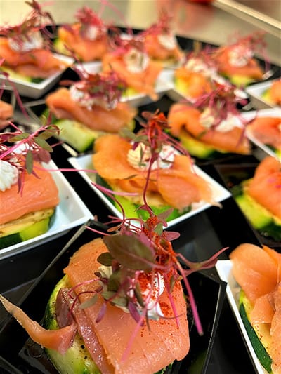 Plated gourmet salmon appetizers with garnishes