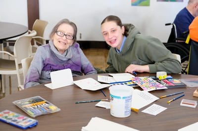 Residents and staff engaging in an art activity