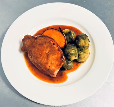 A plated meal with chicken and vegetables