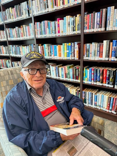 Resident reading in the facility's library