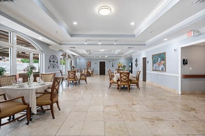Common area with tables and chairs in light colors