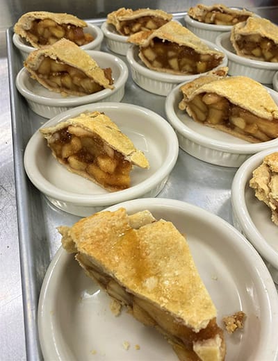 Slices of apple pie in white ramekins