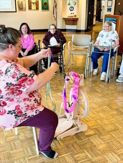 Residents participating in a crafting activity in a common area