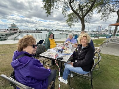 Residents enjoying a meal outdoors by the water