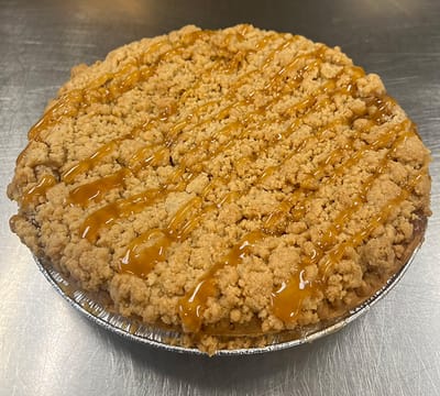 A delicious caramel apple pie on a silver tray