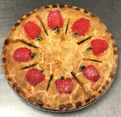 A pie decorated with gummy strawberries