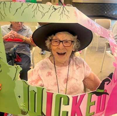 Resident holding a themed photo frame at a celebration