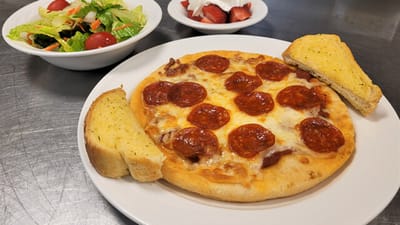 Meal featuring pizza, salad, and dessert