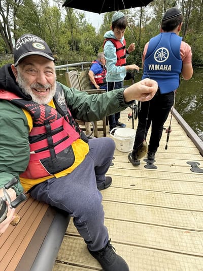 Residents fishing together by the water.