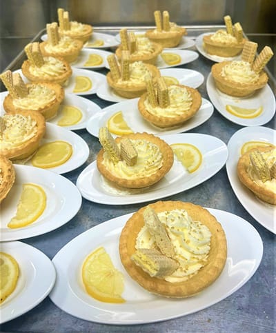 Lemon tart dessert served on white plates
