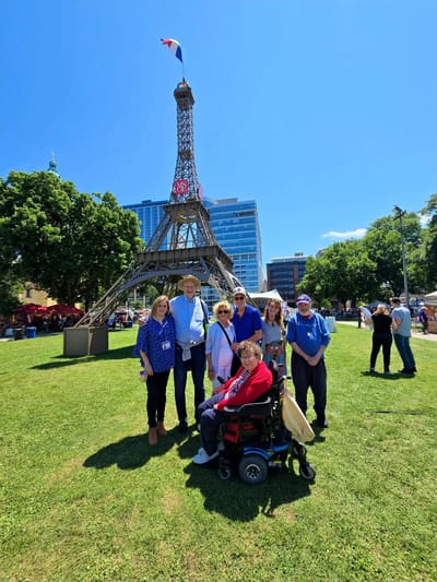 Group of residents outdoors at a park with the Eiffel Tower replica