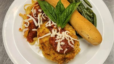 A well-presented meal with pasta, chicken, and vegetables