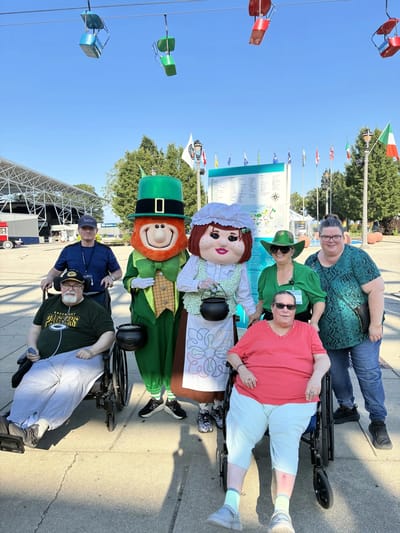Residents with mascots at an outdoor event