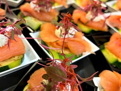 Gourmet appetizers featuring smoked salmon and herbs