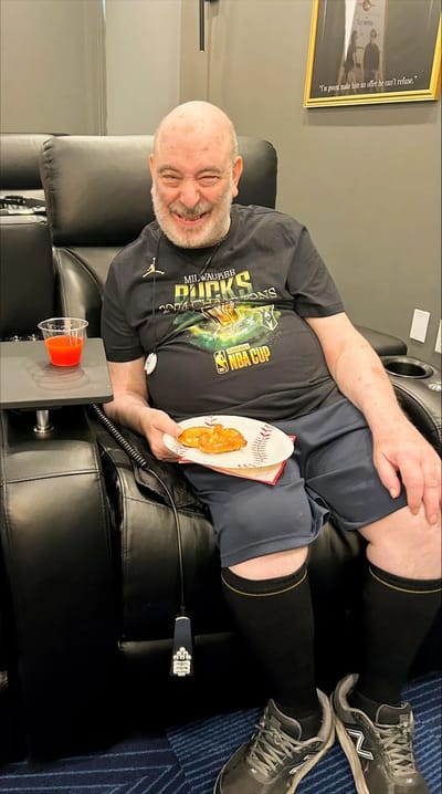 Resident enjoying a snack in a comfortable chair