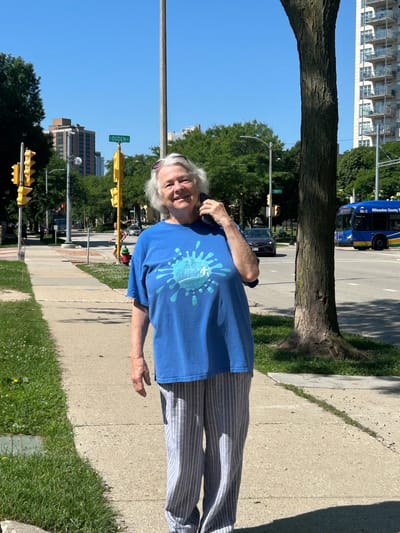Senior woman smiling outdoors on a sunny day