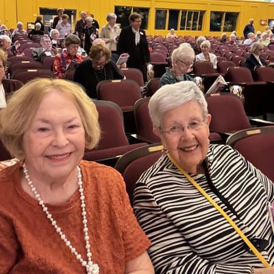 Two residents smiling together at an event