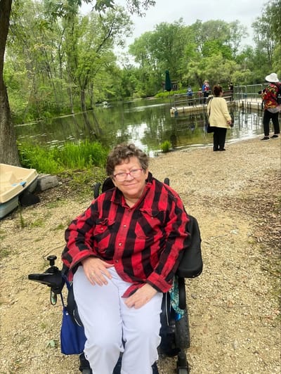 Resident enjoying the outdoor space by a pond